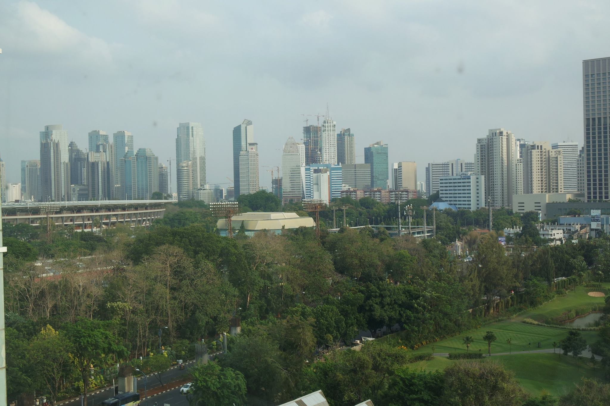 Skyline of Jakarta Indonesia with country clubs and slums side by side