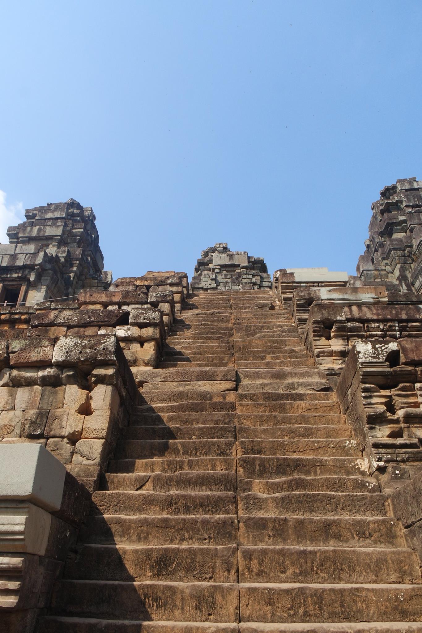 Angkor Wat jungle temple steep stairs Cambodia one arm could climb up down challenge